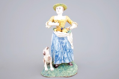 A tall polychrome pottery group of a lady with a dog, Nevers, 18th C.