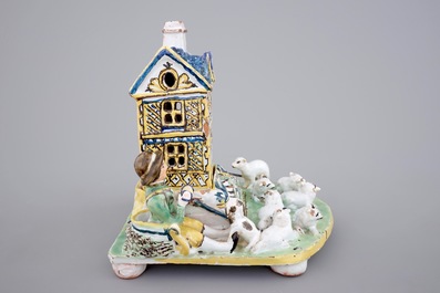 A rare French pottery group with musicians herding sheep by a house, 18th C.