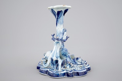 A blue and white Dutch Delft candlestick with a deer and a buddhist, 18th C.