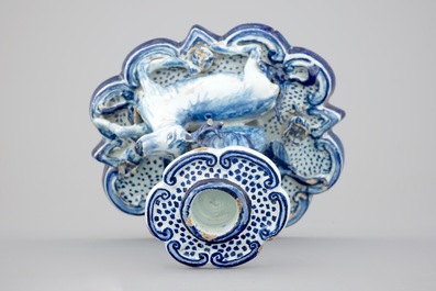 A blue and white Dutch Delft candlestick with a deer and a buddhist, 18th C.