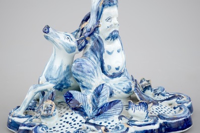 A blue and white Dutch Delft candlestick with a deer and a buddhist, 18th C.