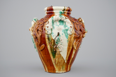 A brown and green glazed relief decorated vase, Saintonge, France, 18th C.