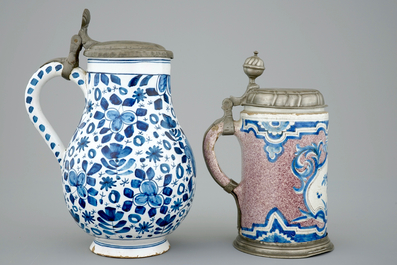 Two pewter-mounted Delft jugs and two blue and white tiles, 17/18th C.