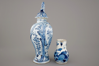 A large Dutch Delft blue and white vase and cover, a plate and a cream jug, 18th C.