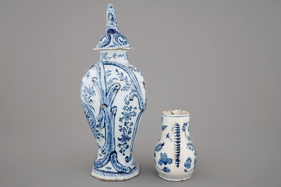 A large Dutch Delft blue and white vase and cover, a plate and a cream jug, 18th C.
