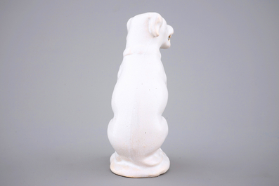 A white monochrome Dutch Delft figure of a dog, 18th C.