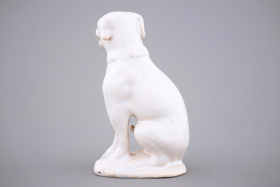 A white monochrome Dutch Delft figure of a dog, 18th C.