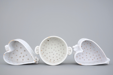 Three white Dutch Delft strainers, round and heart-shaped, 18th C.