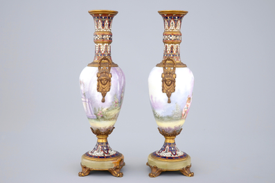 A pair of S&egrave;vres porcelain vases with bronze and champleve enamel mounts, 19th C.