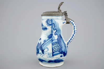 A Dutch Delft blue and white chinoiserie jug with pewter lid, 17th C.