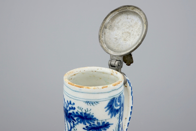 A Dutch Delft blue and white chinoiserie jug with pewter lid, 17th C.