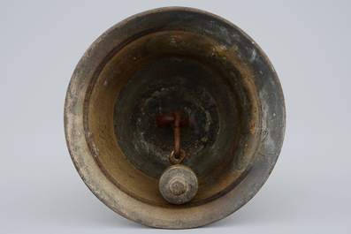 A tall bronze table bell with stylised handle, 16/17th C.