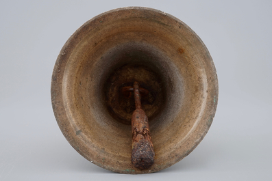 A tall bronze table bell with stylised handle, 16/17th C.