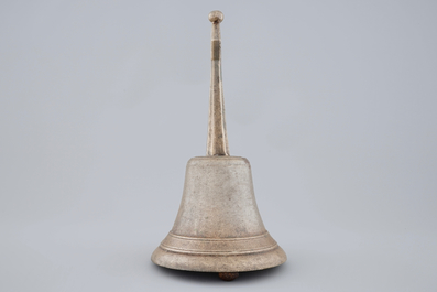 A tall bronze table bell with stylised handle, 16/17th C.