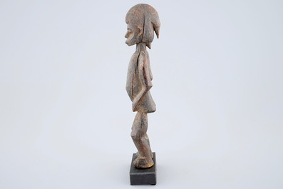 An African carved wood figure, Senufo, Ivory Coast