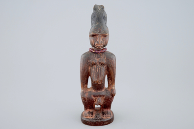 An African carved wood figure, Yoruba, Nigeria, 2nd/3rd quarter of the 20th C.