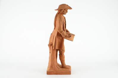 A tall terracotta figure of a hurdy-gurdy player, early 19th C.