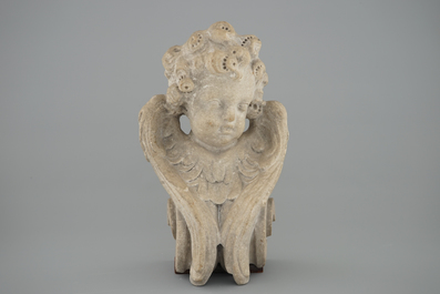 A carved stone head of a putto, France, early 17th C.