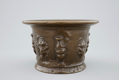 A bronze mortar with applied lion's heads, incl. its pestle, late 16th C.