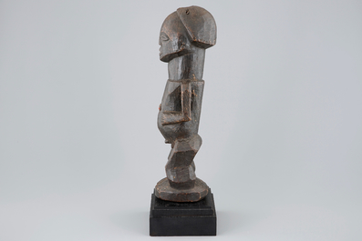 An African carved wood fetish figure on stand, Songye, Congo, mid 20th C.