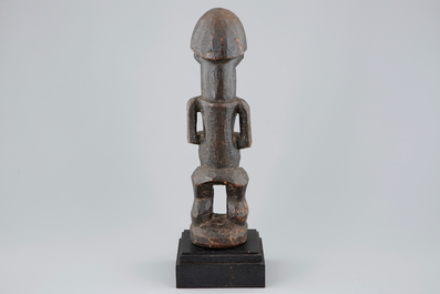An African carved wood fetish figure on stand, Songye, Congo, mid 20th C.