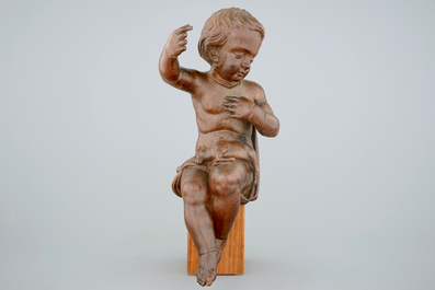A wooden seated figure of the Jesus child with a lamb, 17/18th C.