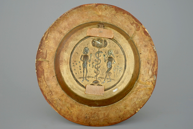 A large broad-rimmed brass alms bowl with Adam and Eve, N&uuml;rnberg, 15th C.