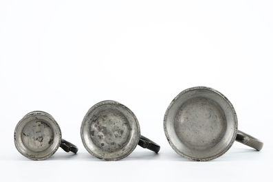 A large collection of pewter, incl. jugs and dishes, and two brass shakers, 17/19th C.