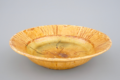 Alfred William Finch (1854 &ndash;1930): A large yellow-glazed slip-decorated ceramic dish