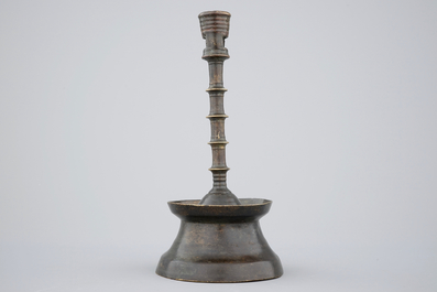 A copper alloy candle stick of dark patina, The Low Countries, late 15th C.