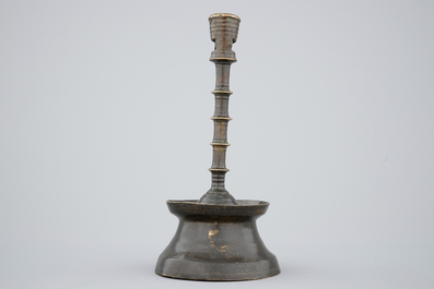 A copper alloy candle stick of dark patina, The Low Countries, late 15th C.