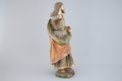 A tall polychrome wood sculpture of a saint, 18th C.