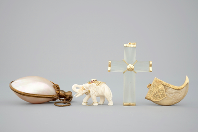 A set of pendants: a mother of pearl scent bottle, a rock crystal and gold cross, a tiger's tooth and an elephant, 19/20th C.