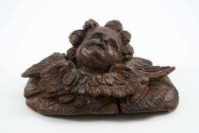 A large carved and patinated wood putto head, 18th C.