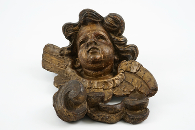 A large carved and gilt wood putto head, 17th C.