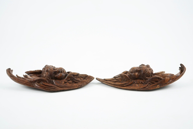 A pair of carved wood putto heads, 18th C.