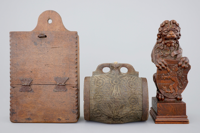 Various wood objects: a lion of Bruges, a butter mold, a cookie mold, a school bag and a wine jug, 18/20th C.