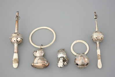 Two rattles and three biting rings in silver and ivory, 18/19th C.