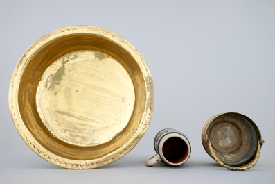 A Malines brass alms dish, a Nuremberg brass alms bowl, an Italian bronze holy water bucket and a Westerwald stoneware beer stein, 16/18th C.
