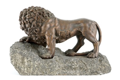 A fine cast iron lion on a stone base, 18th C.