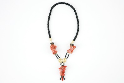 A necklace with three carved coral figures, Italy, 20th C.