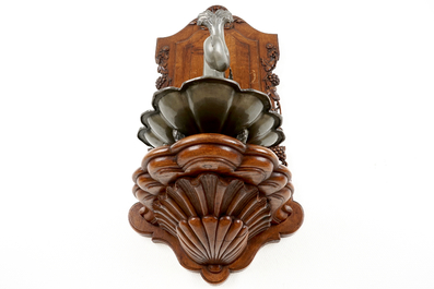 A pewter wall fountain and basin on a carved wood stand, 18/19th C.