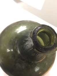 A Dutch green glass wine bottle, 17th C.