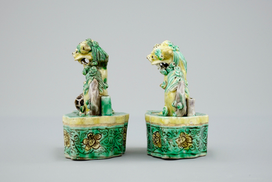 A pair of Chinese verte on biscuit foo dog joss stick holders, Kangxi