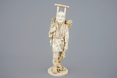 A Japanese carved ivory figure of a lumberjack, Meiji, 19th C.