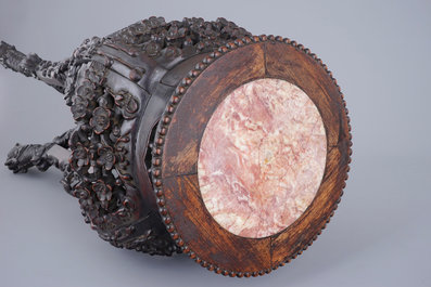 A richly carved Chinese wood stand with marble top, 19/20th C.