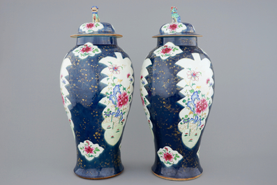 A tall pair of Chinese famille rose powder blue ground vases with covers, Qianlong, 18th C.