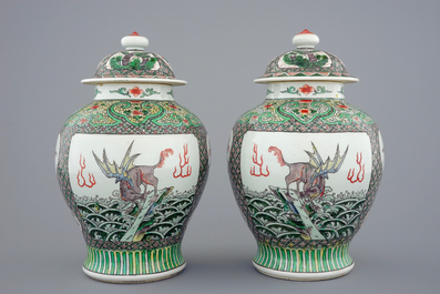 A pair of Chinese famille verte vases and covers with mythical beasts, 19/20th C.