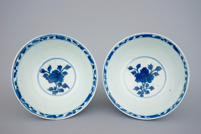 A pair of Chinese blue and white bowls with lions among peony scrolls, late Ming Dynasty