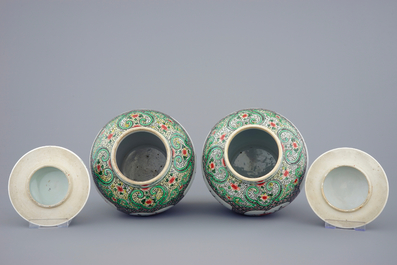 A pair of Chinese famille verte vases and covers with mythical beasts, 19/20th C.